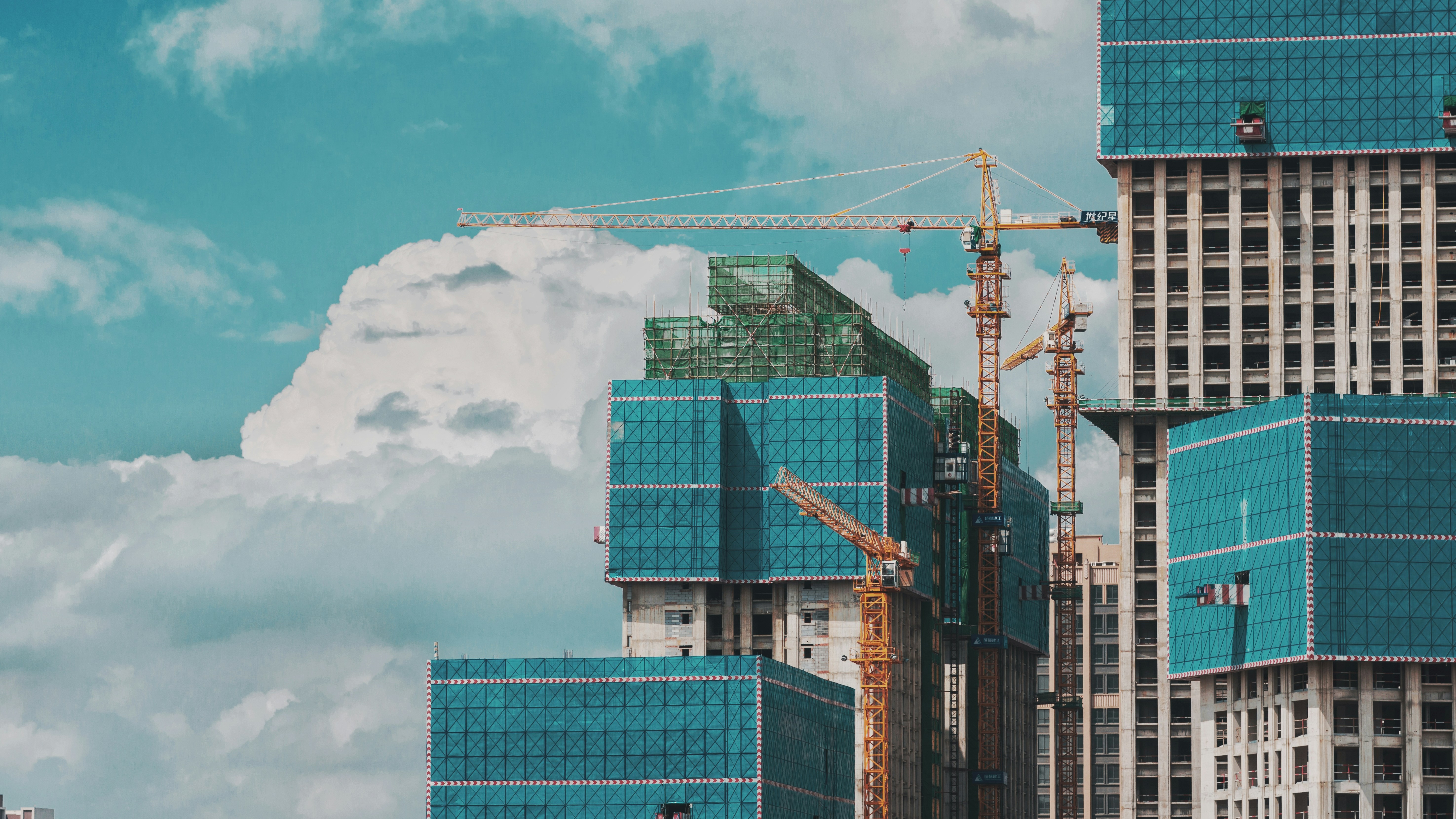 Commercial construction site with steel frames and cranes