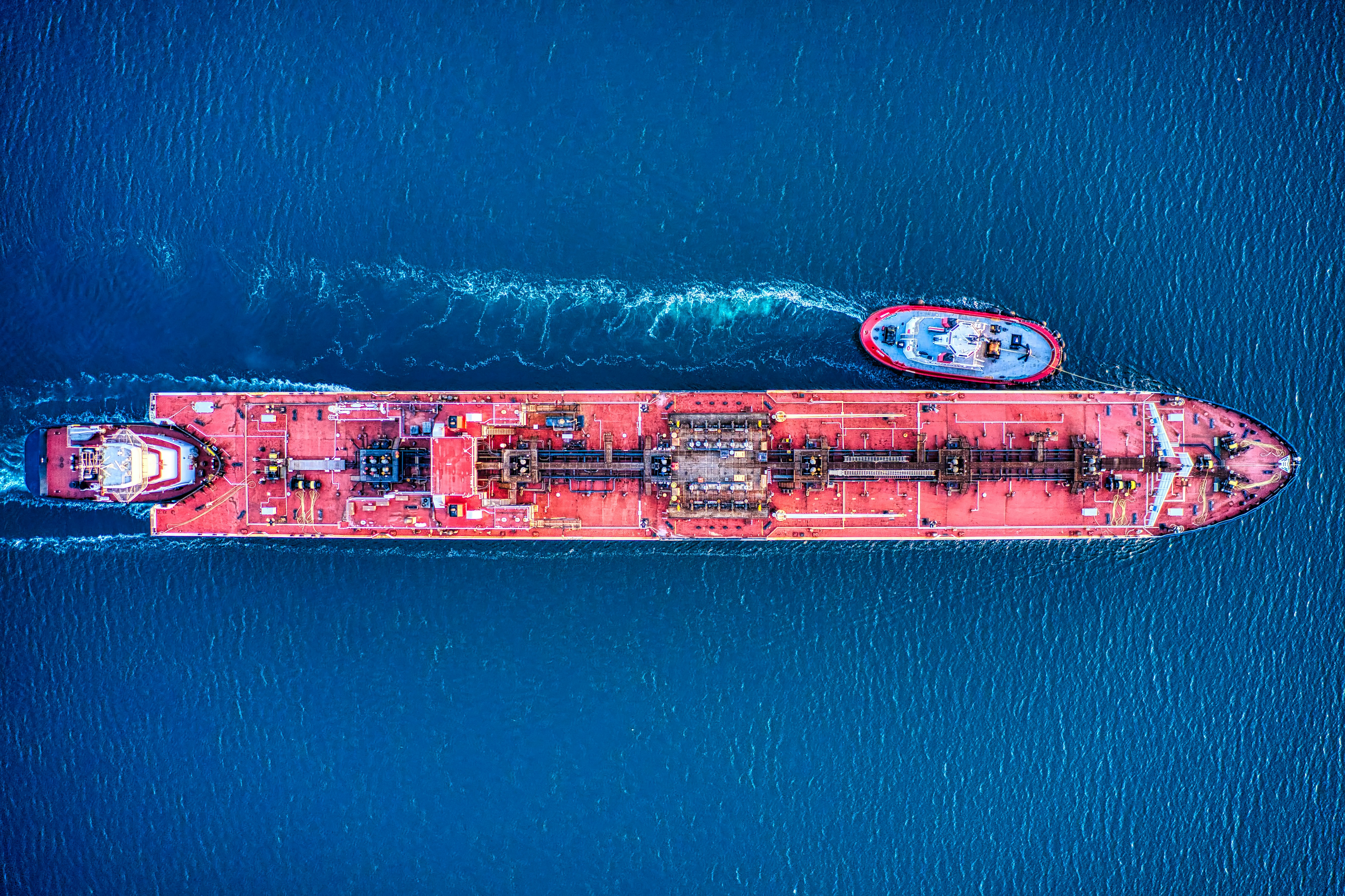Industrial tanker and tugboats in coastal waters